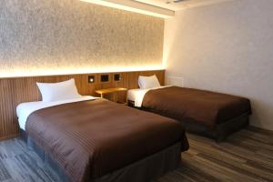 Postel nebo postele na pokoji v ubytování Belmont Hotel