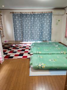 a room with a bed sitting on a rug at Home Stay 北国分 in Ichikawa