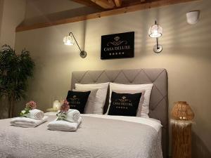 a bedroom with a bed with towels on it at Ferienhaus Casa Deluxe Dockweiler Eifel in Dockweiler +20 photos