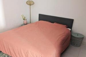a bedroom with a bed with a orange comforter and a lamp at Vivenda Josil - private pool 1km to beach & centre in Lagos +28 photos
