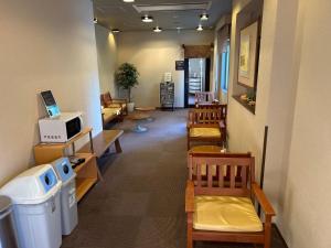 a hallway with chairs and a waiting room with a waiting room at Dormy Inn Express Koriyama in Koriyama
