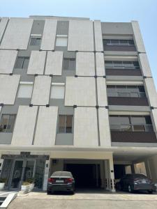 a building with a car parked in front of it at AL Rayan Luxury Apartments in Jeddah