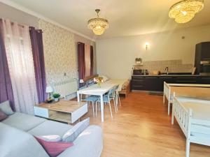 a living room with a couch and a table at "Route 62" Airport Modlin 24h in Goławin