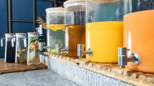 a row of jars on a brick ledge with drinks at The Millennials Fukuoka in Fukuoka