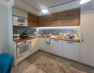 a kitchen with white cabinets and a counter top at Pino - Villa, Casa, Cucina е Terrazza in Albena
