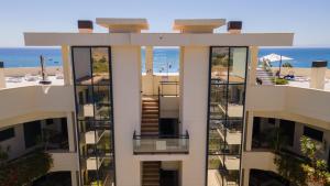an aerial view of a building with the ocean in the background at Hello Cosmo in Estepona