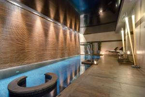 a large swimming pool in a room with a ceiling at Meliá Genova in Genoa