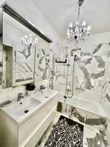 a white bathroom with a sink and a mirror at Four reasons apartment in Prague