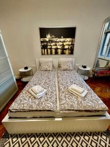 a bedroom with a bed with two towels on it at Four reasons apartment in Prague