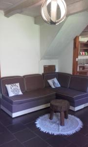 a living room with a couch and a coffee table at Gite Lacroix Barrez in Lacroix-Barrez
