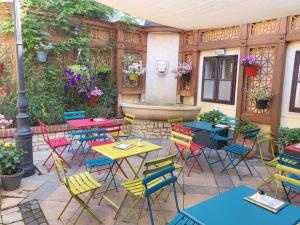 a patio with tables and chairs and a fountain at LUNA City Apartman in Sopron