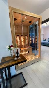 a room with a wooden table and a glass wall at AmurResidence 64 Sauna Parking Barbeque in Iaşi