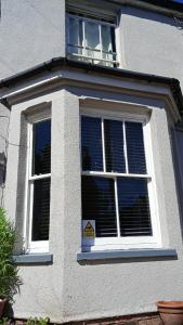 a white house with a window with a sign in it at Number 14 in Ipswich
