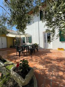 a patio with a table and chairs in front of a building at Casa vacanze Eny in Capannori