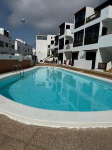 a large swimming pool in front of a building at Azul 41 - Puerto Del Carmen Harbor with Oceanview, pet friendly, Pool in Tías