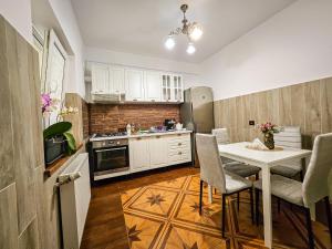 a kitchen with a table and chairs in a kitchen at Chic Flat - 24 H self checkin-free parking in the yard in Floreşti