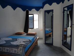 a room with two beds and a mirror at Pensao Zé Doce in Portela