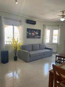 a living room with a couch in the middle of it at Villa Veranos, Rojales, Benijofar, Alicante, Valencia in Rojales