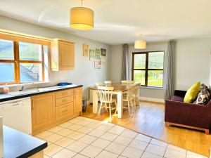 a kitchen and living room with a table and chairs at No's 6, 8 & 9 Dingle Lispole Holiday Homes in Lispole +53 photos
