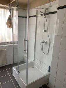 a shower with a glass door in a bathroom at HD Rooms in Bremen +19 photos