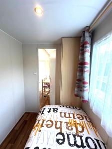 a bedroom with a bed in a room with a window at Cottage 4 in Agarn +10 photos