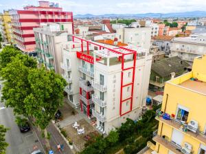 an overhead view of a white building with a red sign on it at Hotel Amicizia in Rimini