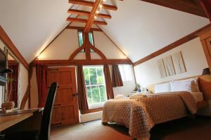 A bed or beds in a room at Tonge Barn 
