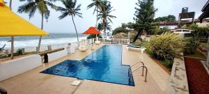 a swimming pool with a view of the ocean at Samudra Villa in Ambalangoda