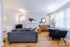 a living room with a couch and a table at Harrogate House Apt 5 - Central Location in Harrogate