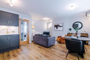 a kitchen and living room with a table and a couch at Harrogate House Apt 5 - Central Location in Harrogate