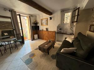 a living room with a couch and a table at Chez kay in Roquebrune-sur-Argens