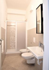 a bathroom with a toilet and a sink and a shower at Republic B&B in Bitonto +51 photos