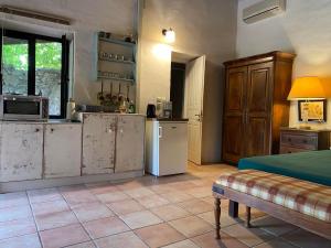 a kitchen with rusty cabinets and a refrigerator at Gentilini Retreat in Argostoli