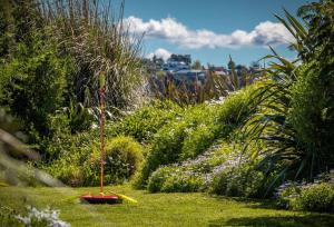a garden with a sprinkler in the grass at Spectacular Ocean View at Ruby Bay in Mapua