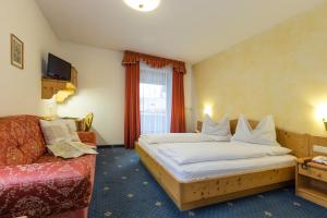 Postel nebo postele na pokoji v ubytování Hotel Urthaler