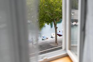 a view from a window of people in boats on the water at Studio Apartments Rijeka in Rijeka