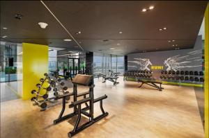 a gym with treadmills and exercise equipment in a building at Luxury Studio Apartment in the Best Location in Dubai