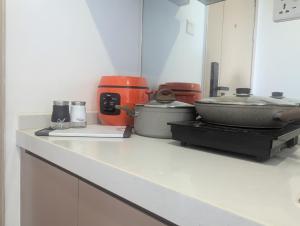 a kitchen counter with various appliances on it at Claudio Homestay - 11th Floor - City Views - 55 UHD TV in Phnom Penh