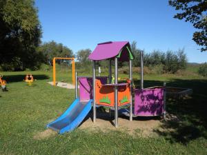 a playground with a slide in a park at Villa Balcsi in Balatonmáriafürdő