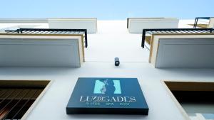 a sign on the side of a building at Aparthotel Luz de Gades - Suites Spa Gym - Adults Only in Cádiz