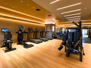a gym with treadmills and exercise equipment in a room at LIBER HOTEL Osaka in Osaka