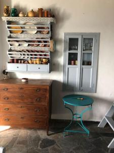 a room with a table and a cabinet with dishes at TaVLaDo Cycladic house in Serifos Chora +24 photos