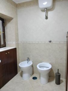 a bathroom with a toilet and a bidet at Sottocielo in Naples