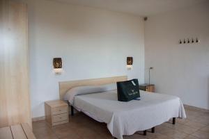 A bed or beds in a room at Hotel Villa Rita