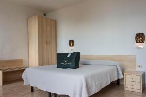 A bed or beds in a room at Hotel Villa Rita