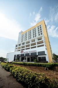 a large white building with a sign on it at Hotel Tamara Melaka in Malacca
