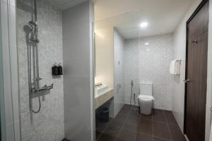 a bathroom with a shower and a toilet and a sink at Hotel Tamara Melaka in Malacca +57 photos