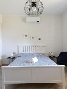 a white bed with a stuffed animal on it at Cogoleto - Villetta Il Canneto in Cogoleto