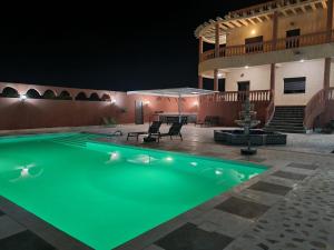 a swimming pool in the middle of a house at night at Villa des Oliviers MEKNES in Meknès +36 photos