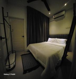 a bedroom with a bed and a door with a window at Homestay Kubang Kerian by The Stay Homestay 03 in Kota Bharu